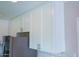 Close-up of kitchen with white cabinets, stainless steel refrigerator and stone countertops at 313 E Westchester Dr, Tempe, AZ 85283