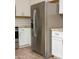 The kitchen features stainless steel refrigerator and appliances, stone countertops, and subway tile backsplash at 313 E Westchester Dr, Tempe, AZ 85283