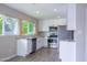 Updated kitchen with white cabinets, stainless steel appliances, and tile flooring at 313 E Westchester Dr, Tempe, AZ 85283