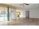 Spacious living room with wood-look tile flooring, ceiling fan, and access to the backyard patio at 313 E Westchester Dr, Tempe, AZ 85283