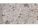 Close-up of modern shower floor features decorative pebble tile and drain at 313 E Westchester Dr, Tempe, AZ 85283