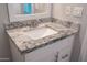 Close-up of bathroom vanity with granite countertop, white cabinets, and stainless steel faucet at 313 E Westchester Dr, Tempe, AZ 85283