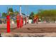 Sandy volleyball court, playground and shade structure with desert trees at 313 E Westchester Dr, Tempe, AZ 85283
