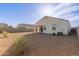 Picture of the backyard with desert landscaping, a covered patio, and privacy wall at 3165 N 306Th Ln, Buckeye, AZ 85396