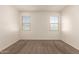 Bright bedroom with carpeted floors and dual windows offering natural light at 3165 N 306Th Ln, Buckeye, AZ 85396