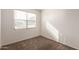 Well-lit room with neutral carpeting, window letting in natural light at 3165 N 306Th Ln, Buckeye, AZ 85396
