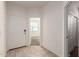 Bright entryway featuring tile flooring, a white front door, and a view into an adjacent carpeted room at 3165 N 306Th Ln, Buckeye, AZ 85396