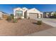 Charming single-story home with a well-maintained yard and a two-car garage, set against a clear blue sky at 3165 N 306Th Ln, Buckeye, AZ 85396