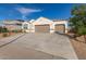 Lovely single-story home with a two car garage, landscaped front yard, and clear blue skies above at 3165 N 306Th Ln, Buckeye, AZ 85396