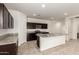 Stylish kitchen featuring granite countertops, a large island, and stainless steel appliances at 3165 N 306Th Ln, Buckeye, AZ 85396