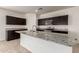 Modern kitchen featuring a spacious island with granite countertops and stainless steel appliances at 3165 N 306Th Ln, Buckeye, AZ 85396