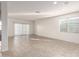Bright, open-concept living room featuring tile flooring, a sliding glass door, and natural light at 3165 N 306Th Ln, Buckeye, AZ 85396
