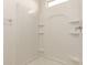 Bright shower stall featuring built-in shelves and easy-to-clean acrylic at 3165 N 306Th Ln, Buckeye, AZ 85396