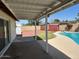 Backyard with pool, concrete patio, rock landscaping, block fence and covered patio area at 3242 W Christy Dr, Phoenix, AZ 85029