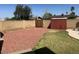 Fenced backyard features rock landscaping, lawn, shed, and block fence at 3242 W Christy Dr, Phoenix, AZ 85029