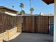 Backyard gate with rock landscaping and tall privacy fence at 3242 W Christy Dr, Phoenix, AZ 85029