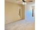 Bedroom has neutral carpeting with ceiling fan, closet, and natural light at 3242 W Christy Dr, Phoenix, AZ 85029