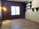 Bedroom featuring wood-like floors, a built-in shelving unit and a window at 3242 W Christy Dr, Phoenix, AZ 85029