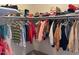 A well-stocked walk-in closet showcasing organized storage with clothing, shoes, and boxes at 3242 W Christy Dr, Phoenix, AZ 85029
