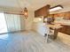 A dining area features tile flooring and a marble breakfast bar near the kitchen space at 3242 W Christy Dr, Phoenix, AZ 85029