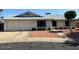 Single-story home with a two-car garage, desert landscaping, and low-maintenance yard at 3242 W Christy Dr, Phoenix, AZ 85029