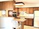 Well-lit kitchen featuring a breakfast bar, ample storage, and white appliances at 3242 W Christy Dr, Phoenix, AZ 85029