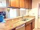 Kitchen with elegant marble countertop, stainless steel dishwasher, and wood cabinets at 3242 W Christy Dr, Phoenix, AZ 85029