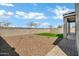This backyard features rock landscaping, a patch of artificial grass and a covered patio at 4140 E Caitlin Dr, San Tan Valley, AZ 85140