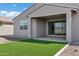 The backyard features an easy-care artificial grass area and a covered patio, ideal for relaxing outdoors at 4140 E Caitlin Dr, San Tan Valley, AZ 85140