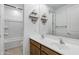 Bathroom with double sinks, wood cabinets, and decorative shelving at 4140 E Caitlin Dr, San Tan Valley, AZ 85140