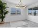 A bright dining room showcases a modern chandelier and large windows for natural light at 4140 E Caitlin Dr, San Tan Valley, AZ 85140
