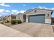 Front exterior view showcases the home's two-car garage, stone driveway, and tidy landscaping at 4140 E Caitlin Dr, San Tan Valley, AZ 85140