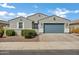 Charming single-story home with a grey exterior, well-maintained landscaping, and a spacious two-car garage at 4140 E Caitlin Dr, San Tan Valley, AZ 85140