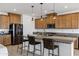 An open concept kitchen with granite countertops, stainless steel appliances, and a breakfast bar at 4140 E Caitlin Dr, San Tan Valley, AZ 85140