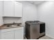 Well-lit laundry room equipped with a modern washer and dryer and plenty of cabinet storage space at 4140 E Caitlin Dr, San Tan Valley, AZ 85140