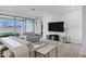 Bright living room features contemporary furnishings, neutral tones, a large window, and access to patio at 4140 E Caitlin Dr, San Tan Valley, AZ 85140
