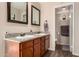 Well-lit bathroom featuring dual sinks, granite countertops, and new wood-look flooring at 4305 E Cherokee St, Phoenix, AZ 85044