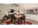 Inviting dining room area featuring a wooden table, ceiling fan, and seamless flow into the kitchen at 4305 E Cherokee St, Phoenix, AZ 85044