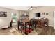 Dining room featuring a black and wood table set, brick accent wall, and wine storage at 4305 E Cherokee St, Phoenix, AZ 85044