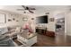 Comfortable living room featuring hardwood floors, ceiling fan, and decorative fireplace at 4305 E Cherokee St, Phoenix, AZ 85044