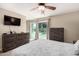 Serene main bedroom featuring a ceiling fan, sliding glass door access to the yard, and neutral decor at 4305 E Cherokee St, Phoenix, AZ 85044