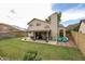 Backyard featuring a patio with seating, a grill, and a lush lawn with decorative planters at 4423 W Escuda Dr, Glendale, AZ 85308
