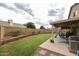 Backyard features a well-maintained lawn, patio and block fence with planters at 4423 W Escuda Dr, Glendale, AZ 85308