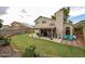 Expansive backyard with lush lawn, covered patio, and desert landscaping, perfect for outdoor living at 4423 W Escuda Dr, Glendale, AZ 85308