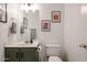 Bathroom featuring a custom vanity, toilet, framed artwork, and modern fixtures and lighting at 4423 W Escuda Dr, Glendale, AZ 85308