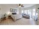 Bright bedroom with wood floors, ceiling fan, and large windows with sitting area at 4423 W Escuda Dr, Glendale, AZ 85308