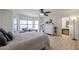 Bright bedroom featuring wood floors, neutral colors, and ensuite bathroom at 4423 W Escuda Dr, Glendale, AZ 85308