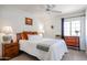 Warm bedroom features a ceiling fan and matching wooden nightstands and dressers at 4423 W Escuda Dr, Glendale, AZ 85308