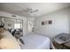 Comfortable bedroom with a large mirror, ceiling fan, and a cozy chair at 4423 W Escuda Dr, Glendale, AZ 85308
