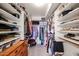 Walk-in closet featuring shelving, clothing racks, and ample storage space at 4423 W Escuda Dr, Glendale, AZ 85308